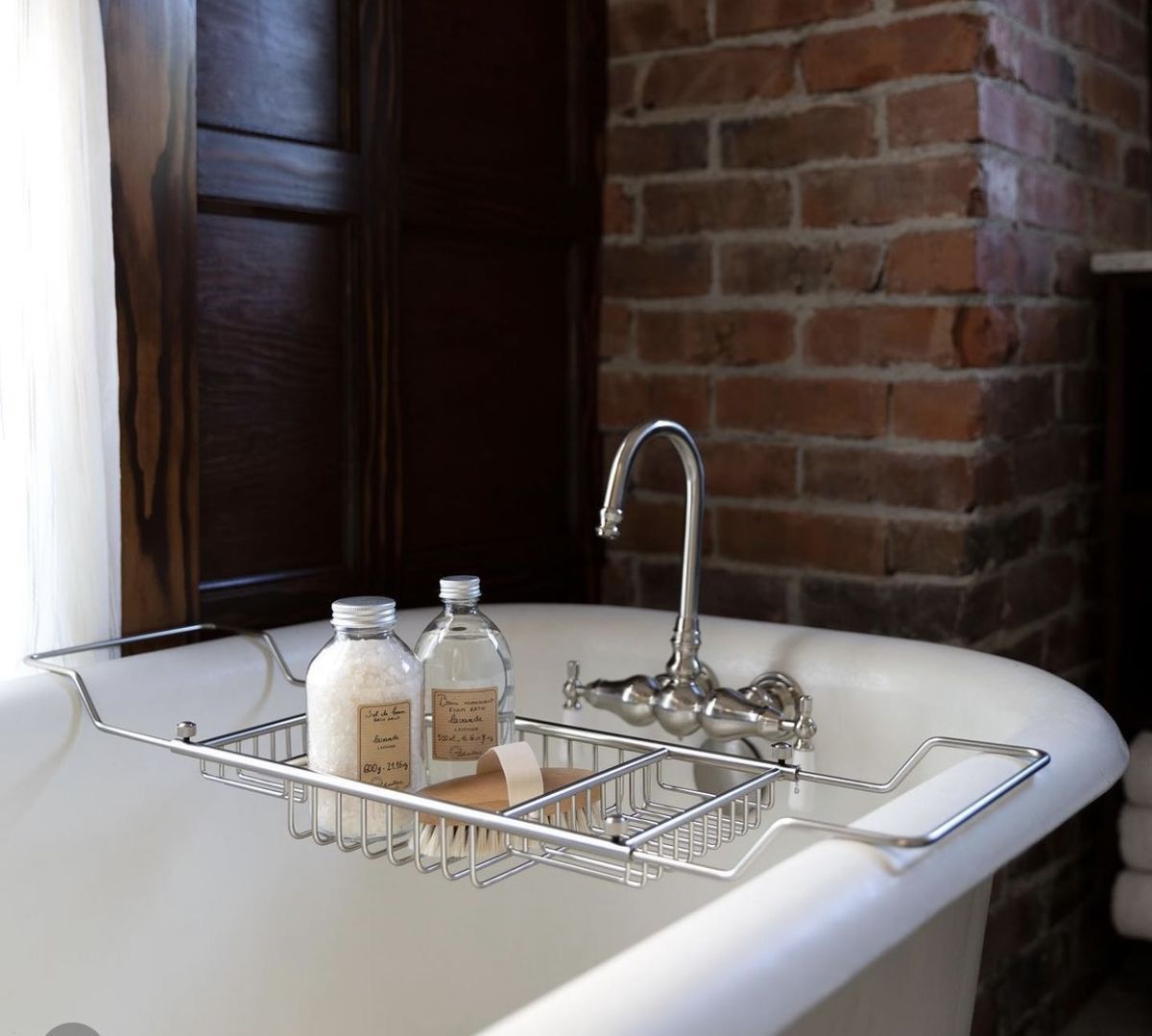 Bathtub caddy spa flatlay with candle and towels