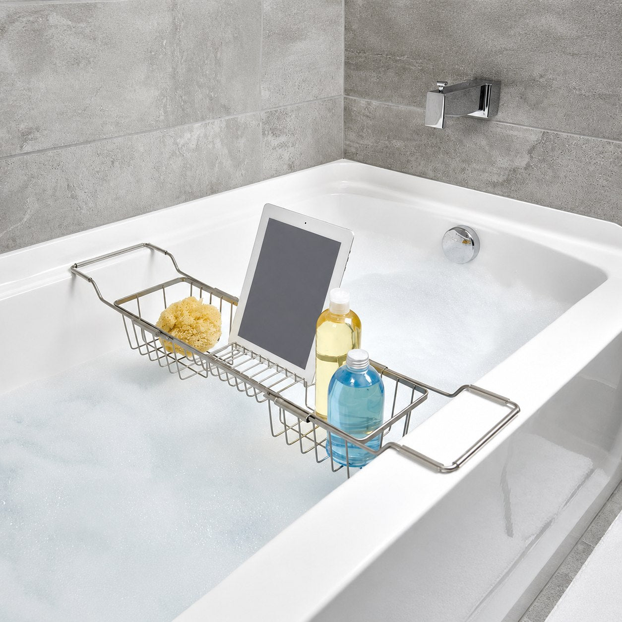Stainless steel bathtub caddy on a white tub